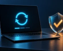 Open laptop with a cyan update symbol beside a glass shield