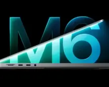 Partly open MacBook Pro with a turquoise M6 graphic on its display and the chip logo behind it